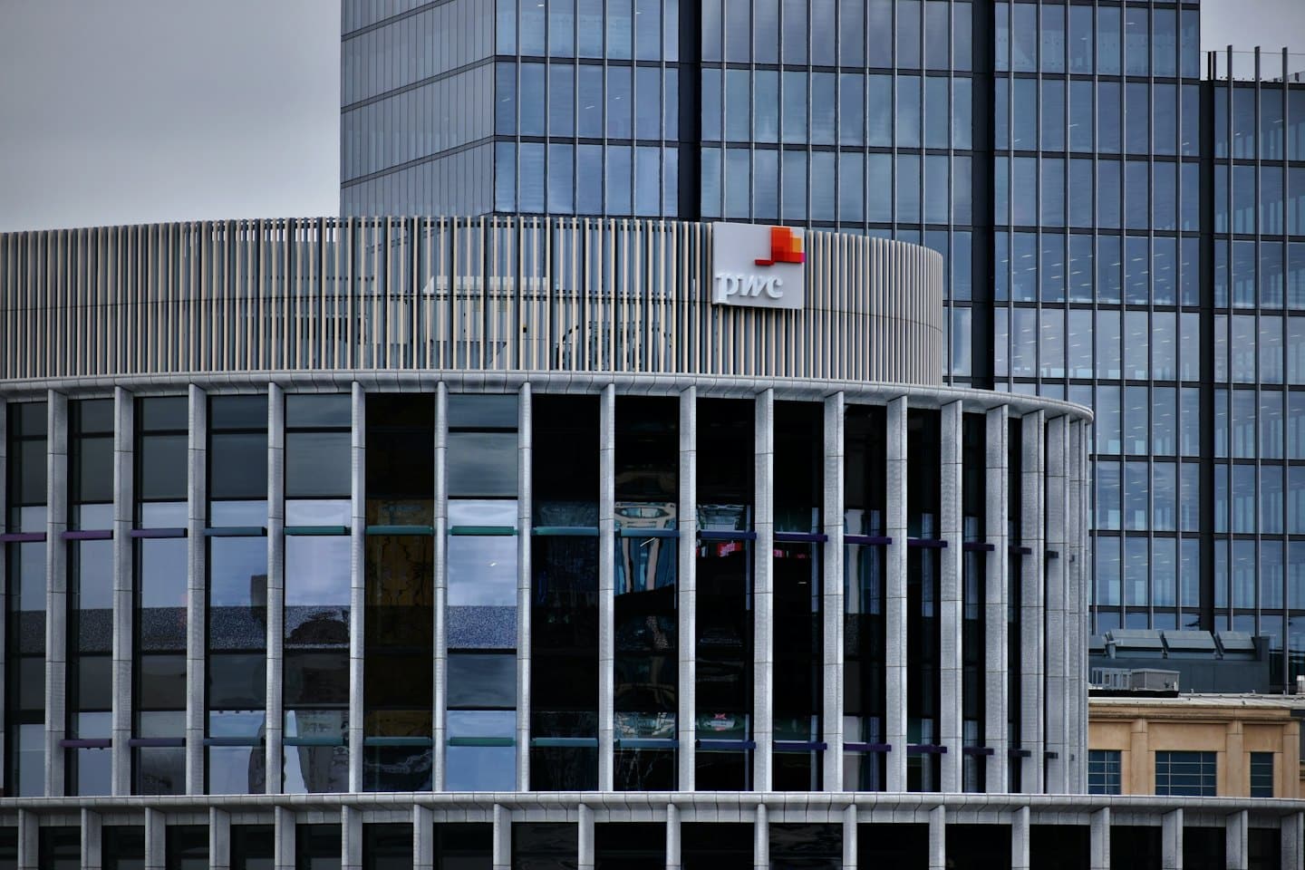 PWC corporate building with metallic fins and glass windows.